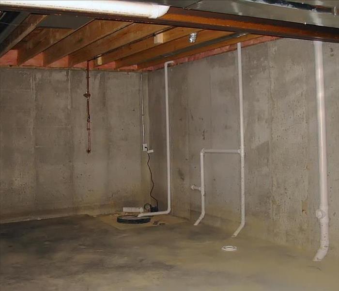 Concrete pad and walls, PVC pipes, and a sump pump