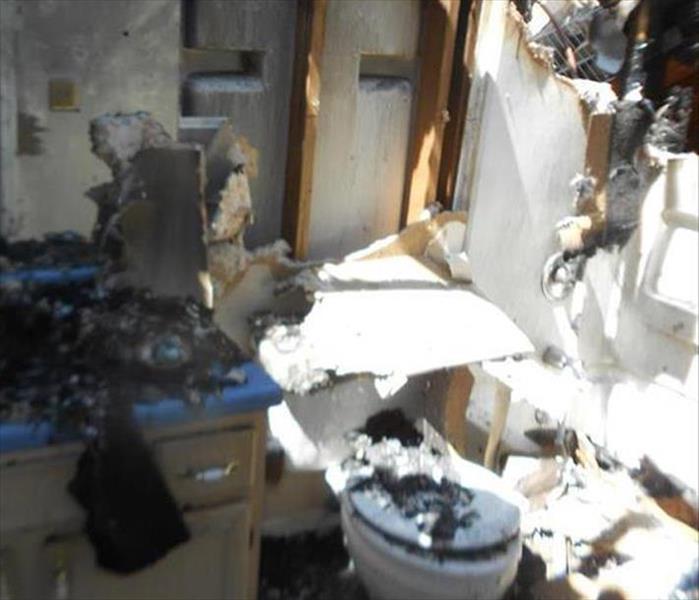 debris fallen, charred, the toilet seat in a bathroom